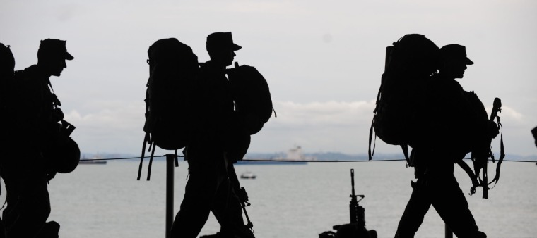 silhouettes of military soldiers walking